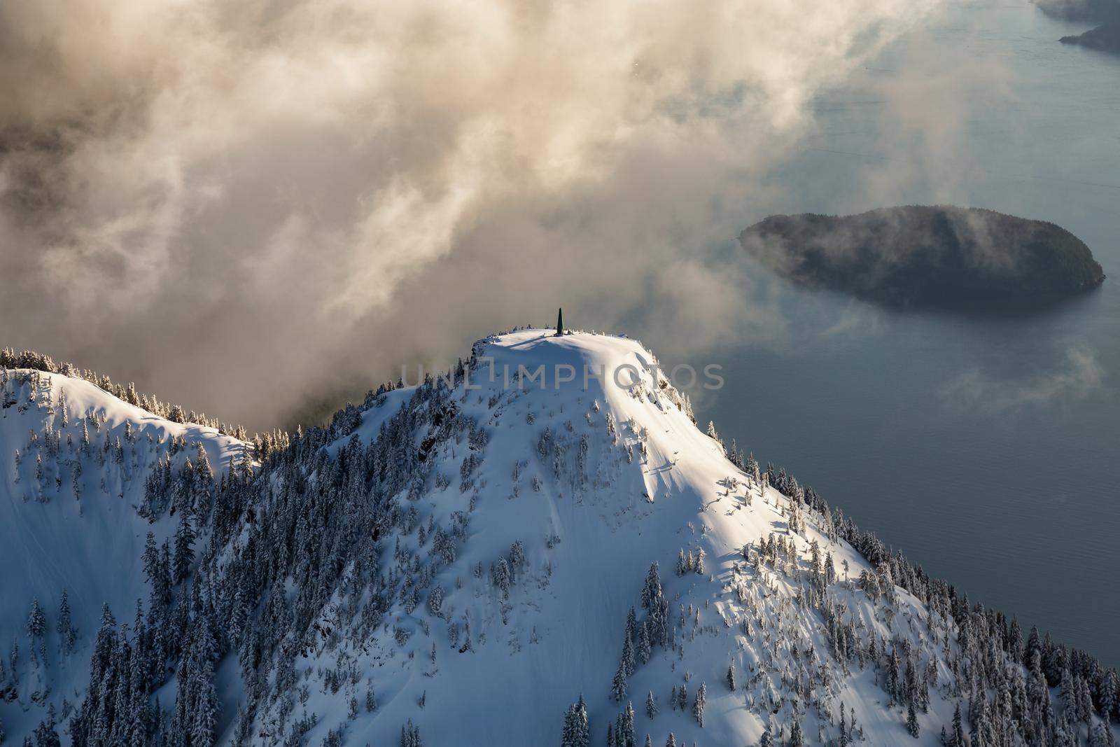 Communication beacon on top of the snowy mountain. Picture taken near Howe Sound, North of Vancouver, BC, Canada.