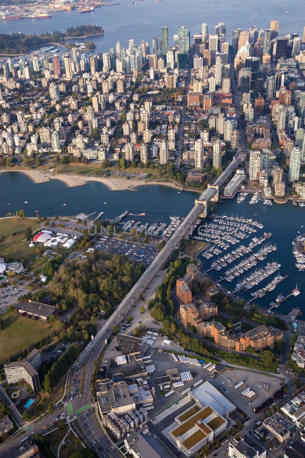 Aerial city view of Downtown Vancouver, Burrard Bridge, and False Creek. Picture taken in British Columbia, Canada, during a sunny evening.