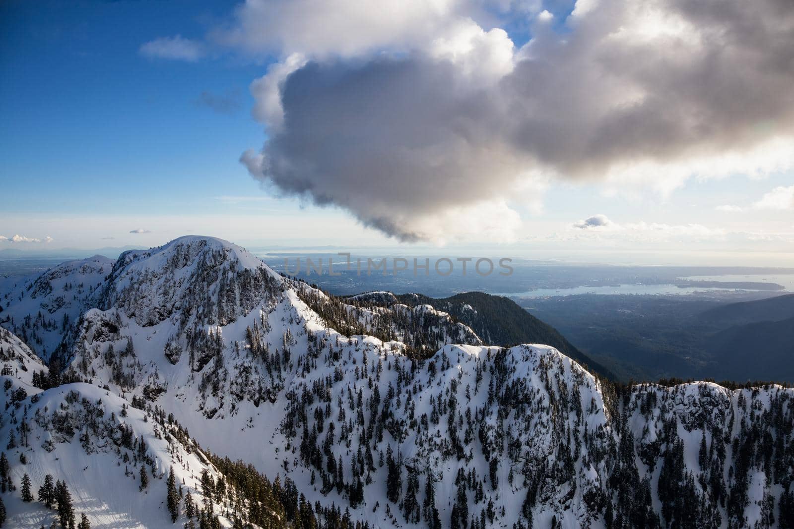 Aerial landscape view of Mt Seymour Provincial Park during a cloudy evening before sunset. Picture taken in Vancouver North Shore Mountains, BC, Canada.