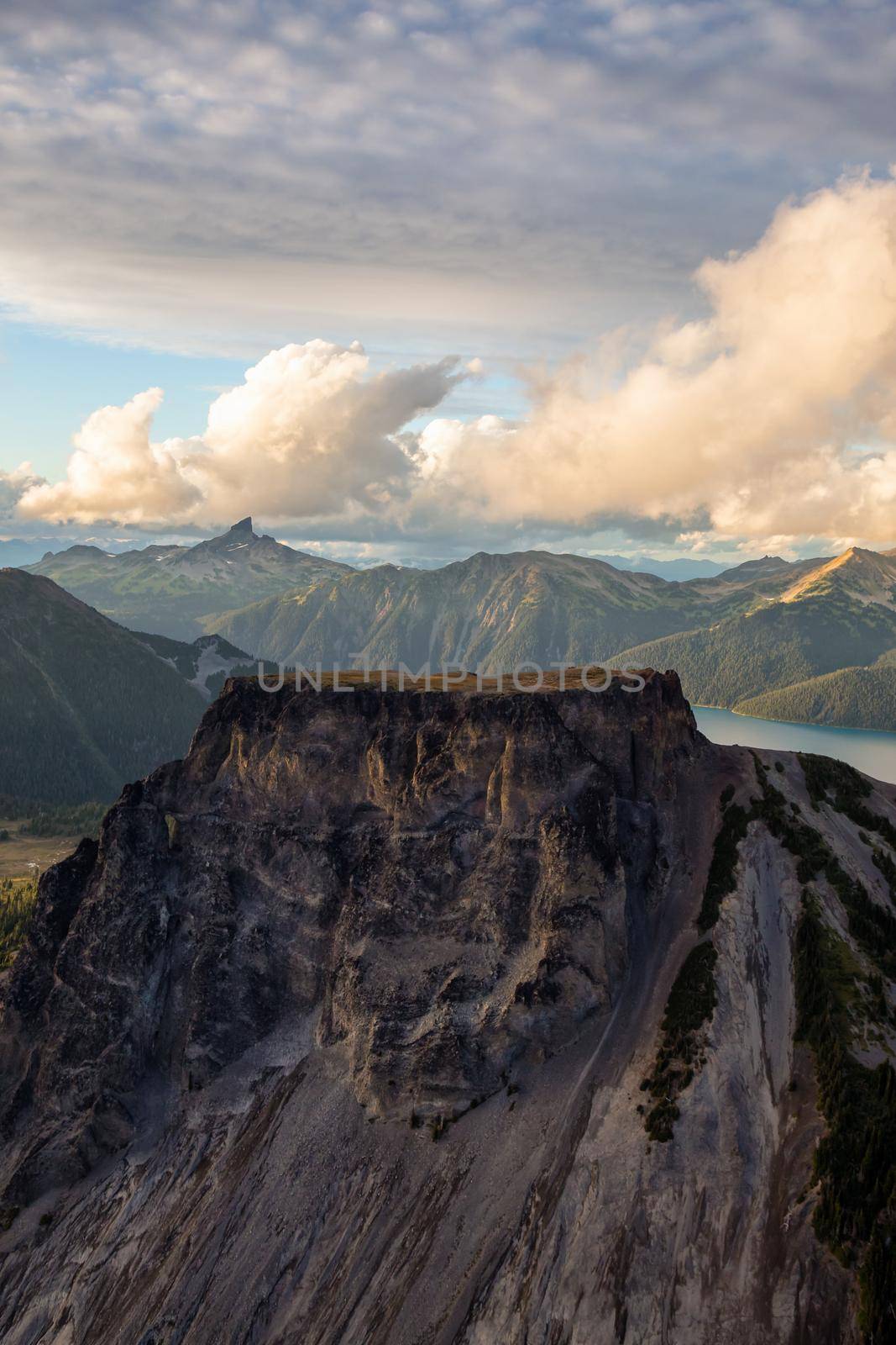 Aerial landscape view of Table Mountain with Black Tusk in the background. Picture taken in Garibaldi, BC, Canada, during a cloudy sunset.