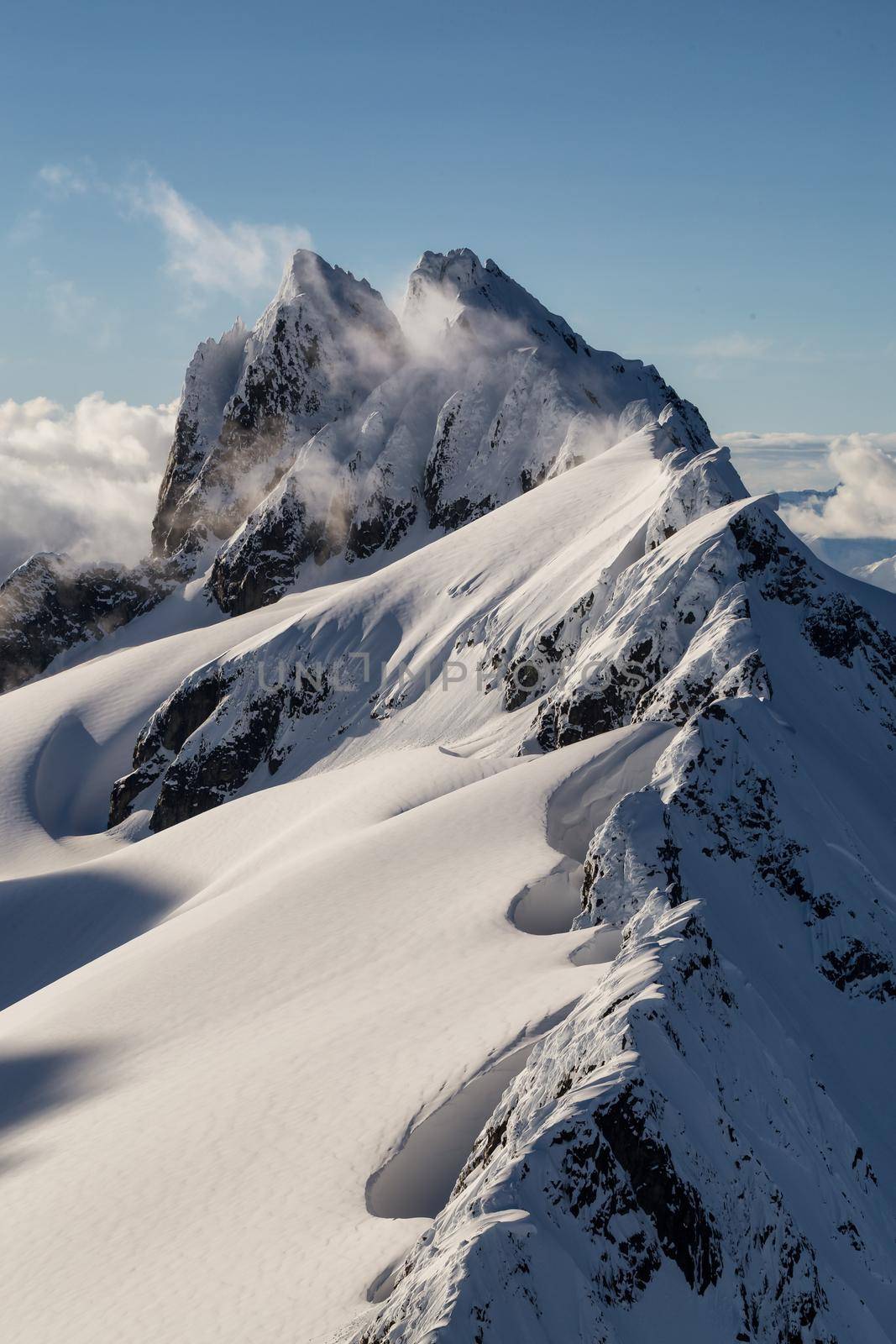 Aerial landscape view of a beautiful mountain (Tantalus Range) in Squamish, British Columbia, Canada.