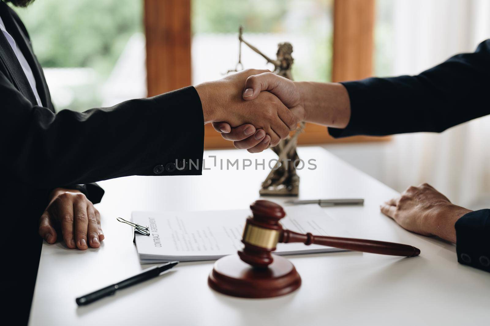 Businessman shaking hands to seal a deal Judges male lawyers Consultation legal services Consulting in regard to the various to plan the case.