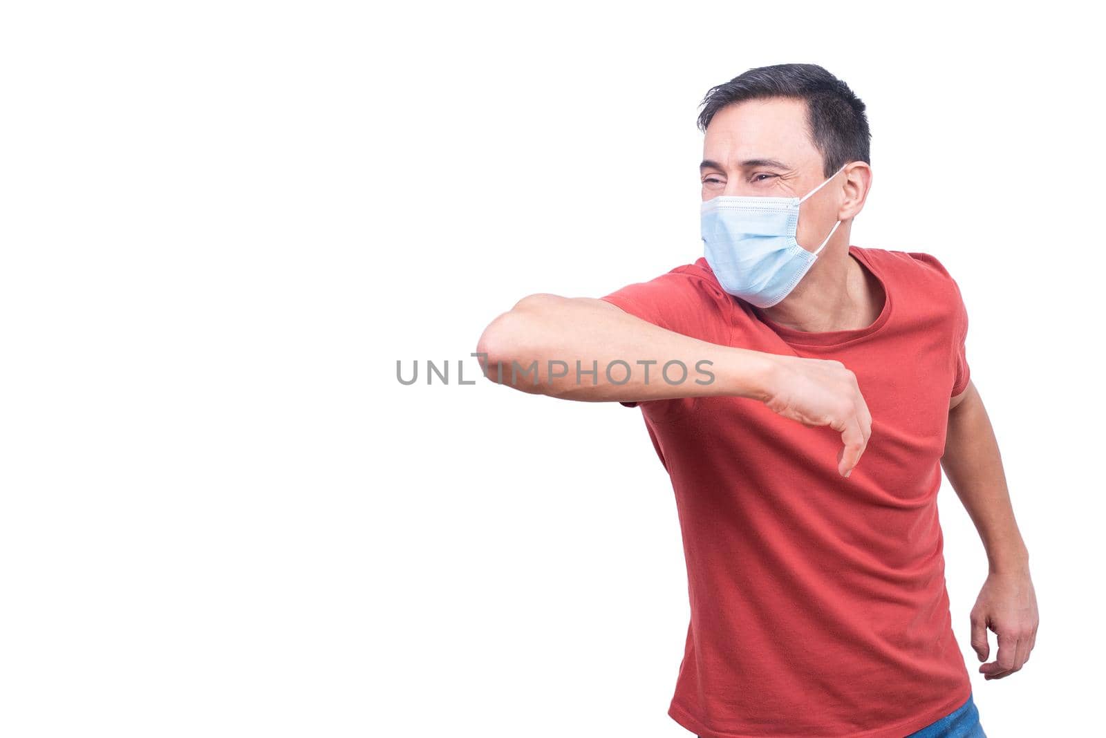 Content male in medical mask doing greeting gesture with elbow bump during coronavirus pandemic isolated on white background in studio