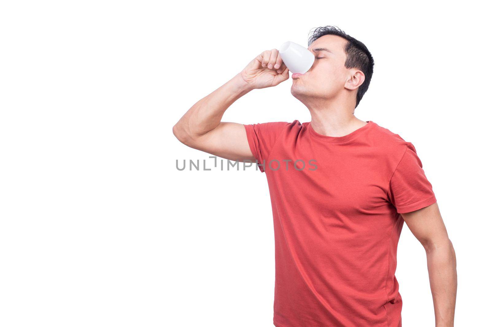 Guy drinking coffee from cup on white background by ivanmoreno