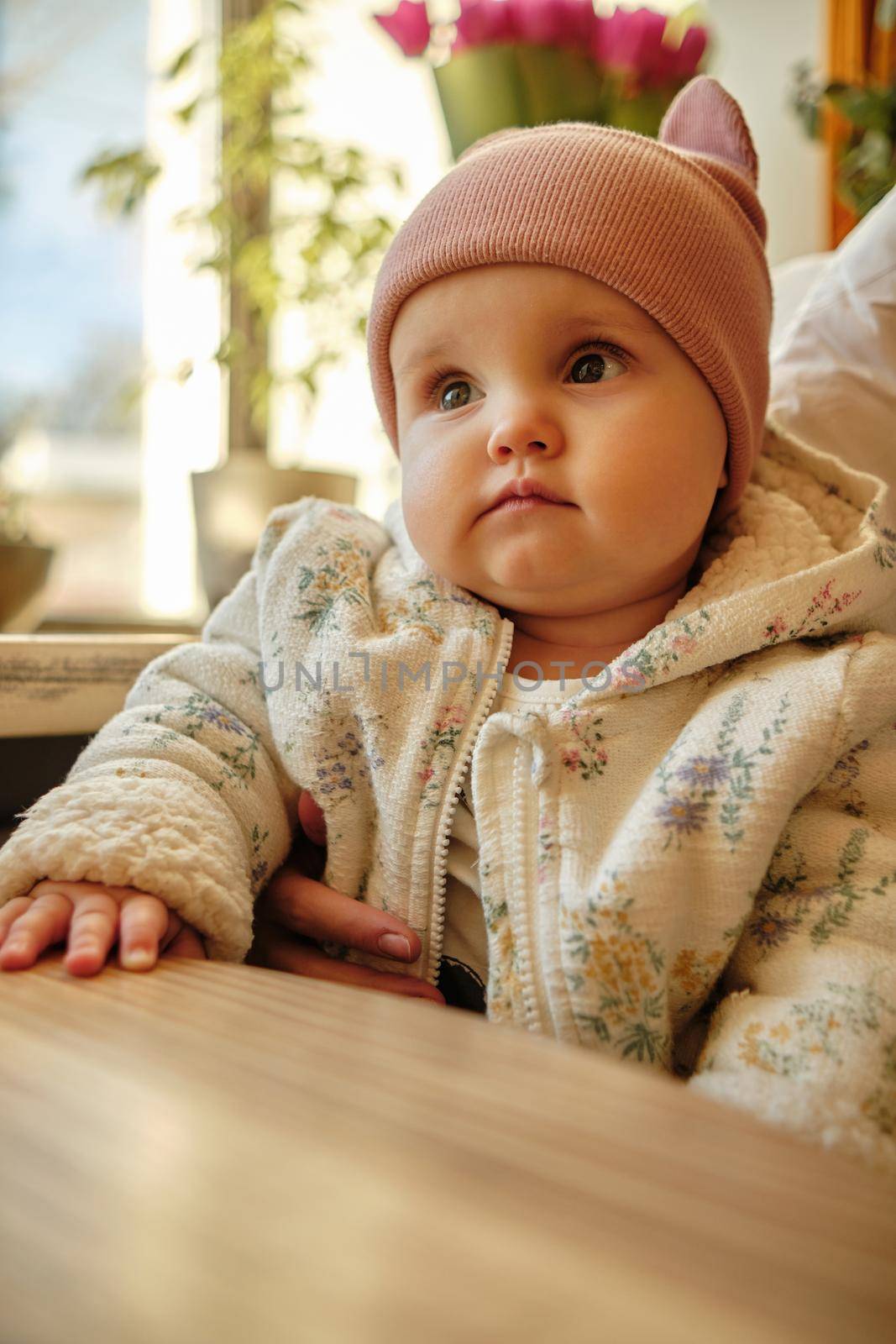 Little baby boy having piece of bread sunny