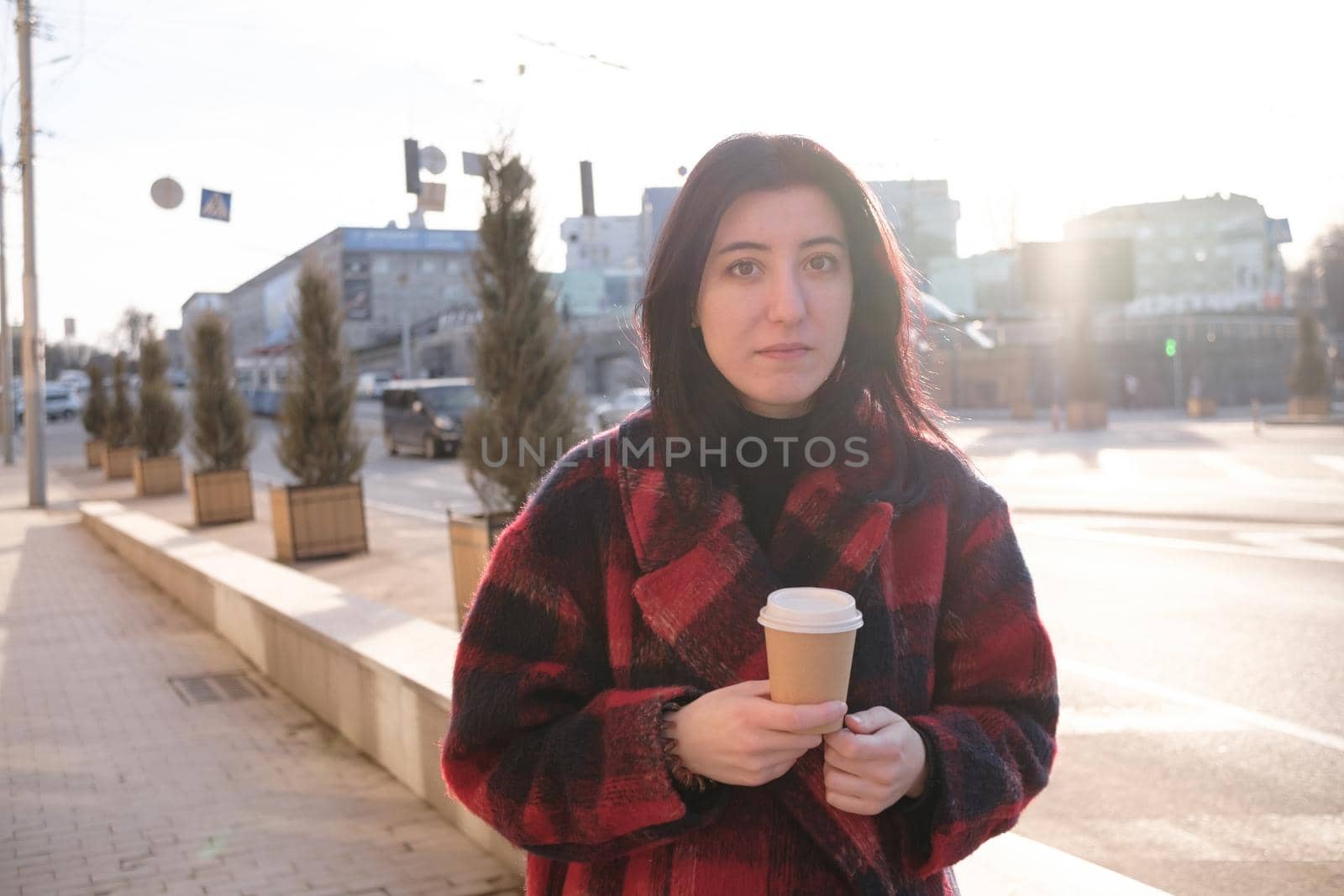 Woman drinking coffee in the sun, outdoor in sunlight light, enjoying her morning coffee. by Symonenko