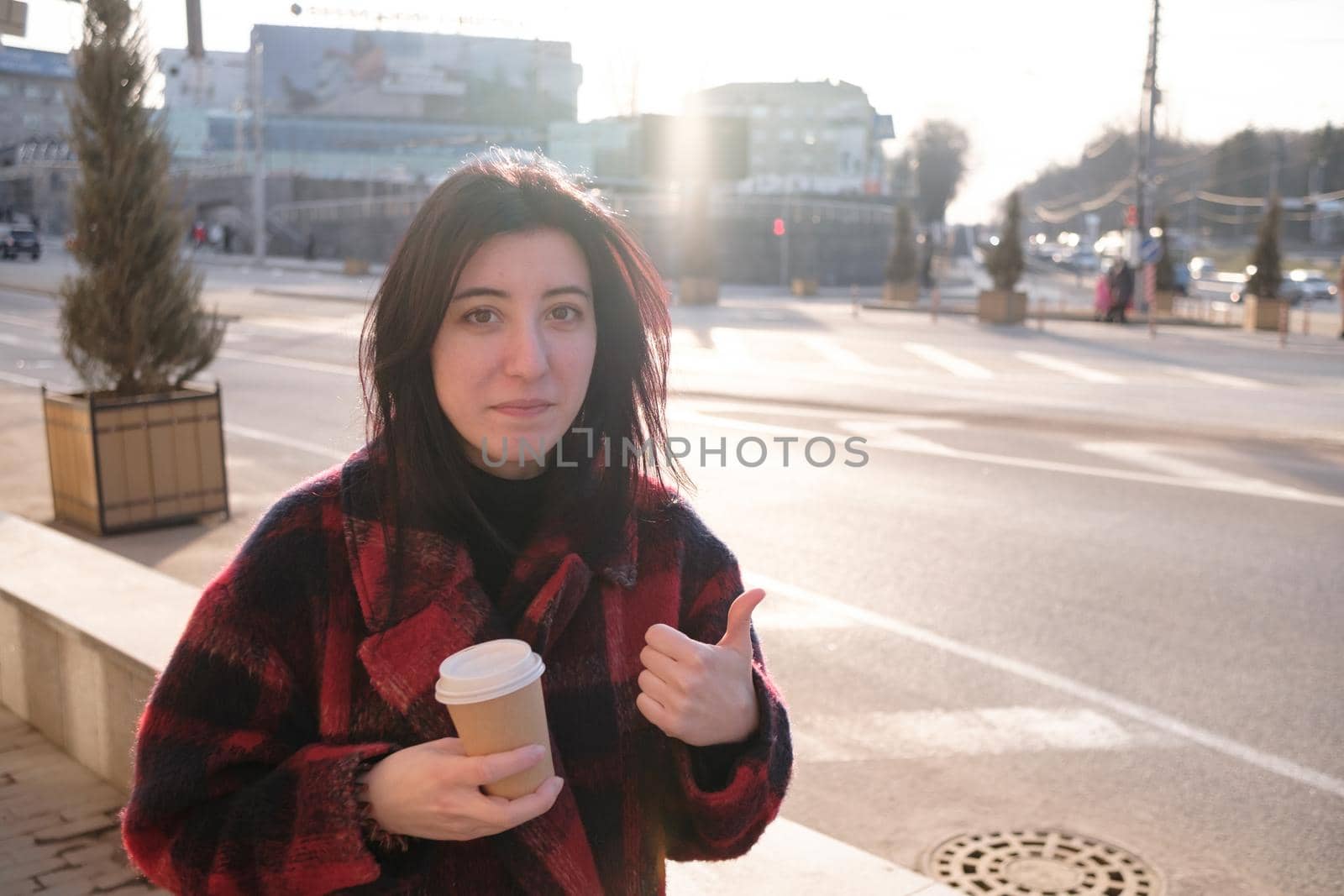 Woman drinking coffee in the sun, outdoor in sunlight light, enjoying her morning