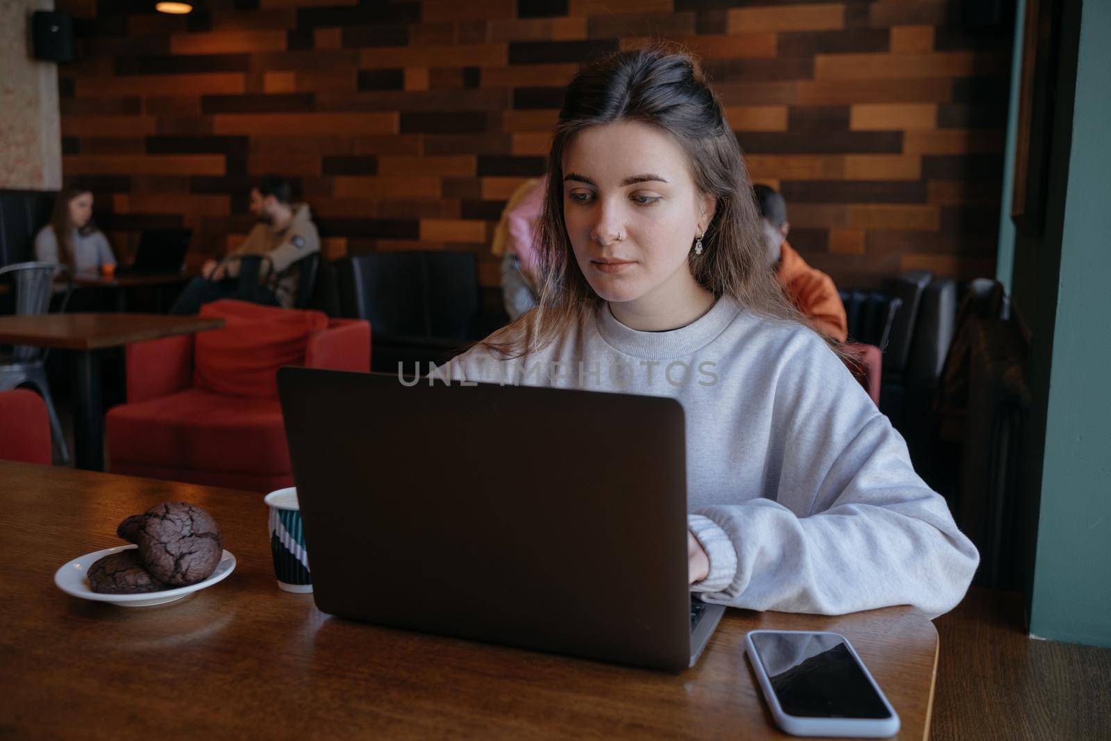 freelance woman happy working in a cafe remotely brunette