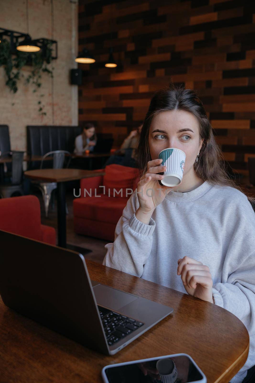 freelance woman happy working in a cafe remotely brunette