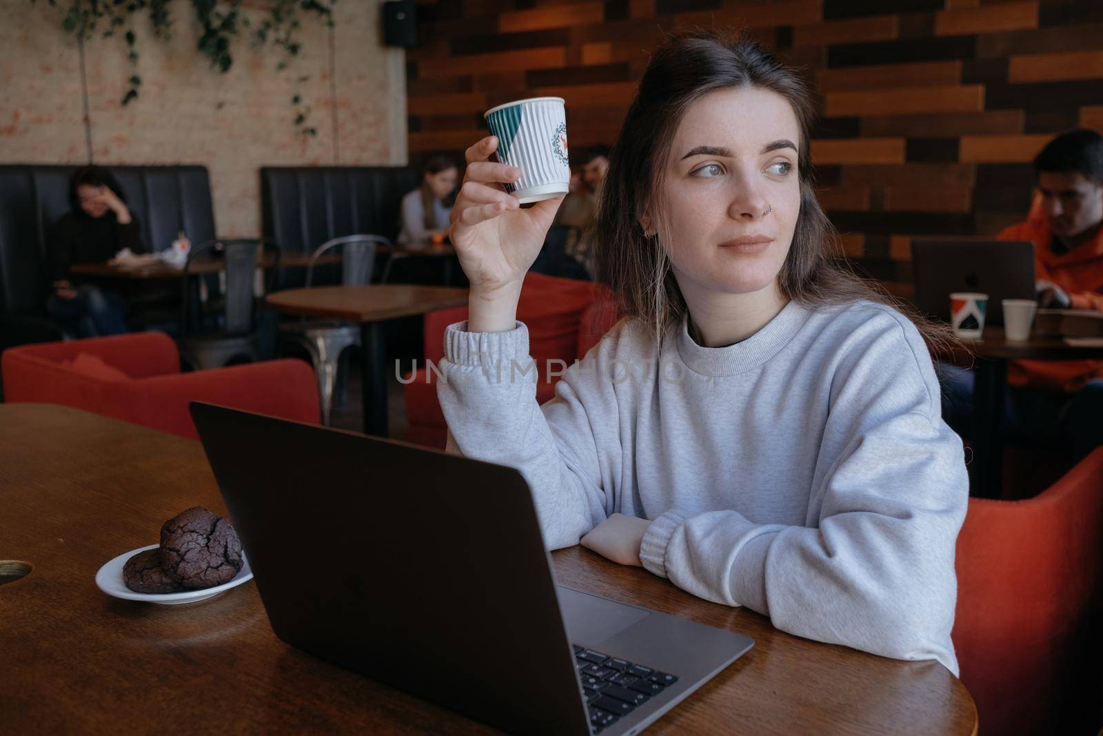 freelance woman happy working in a cafe remotely brunette