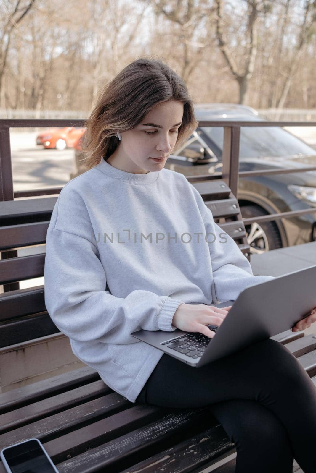 Photo of funky adorable young woman sit near fountain break from work look laptop drink coffee wear pants shirt top bag in park outdoors