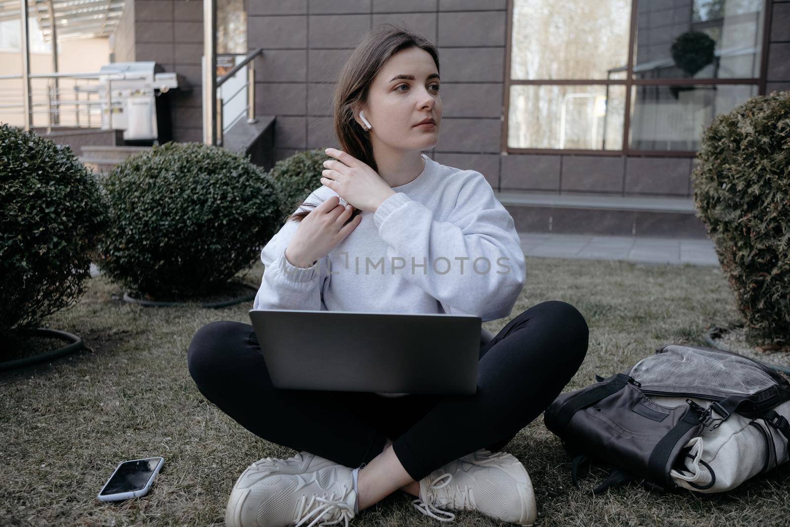 Workation outdoor. Woman working on laptop in park. Distant remote job work during quarantine coronavirus covid-19. Student studying learning online. Video blogger doing live stream.