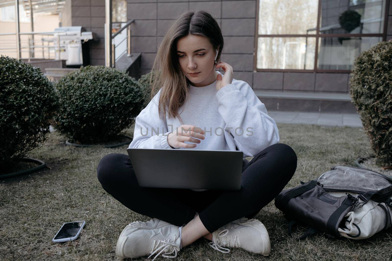 Workation outdoor. Woman working on laptop in park. Distant remote job work during quarantine coronavirus covid-19. Student studying learning online. Video blogger doing live stream.