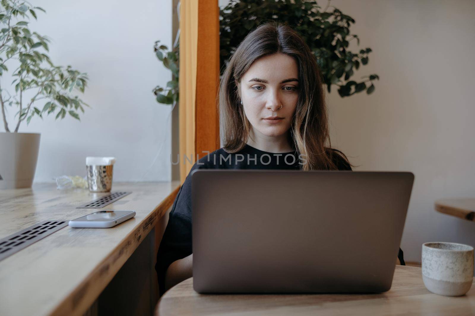 freelance woman happy working in a cafe remotely brunette