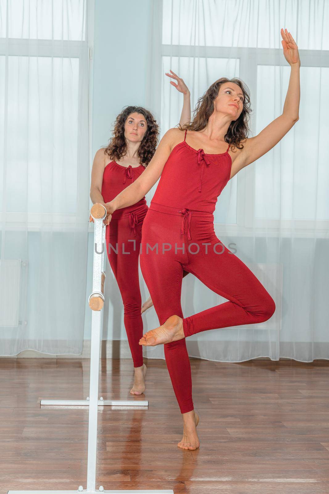 I train with a friend. Two young women train together in a bright training room near a choreographic machine