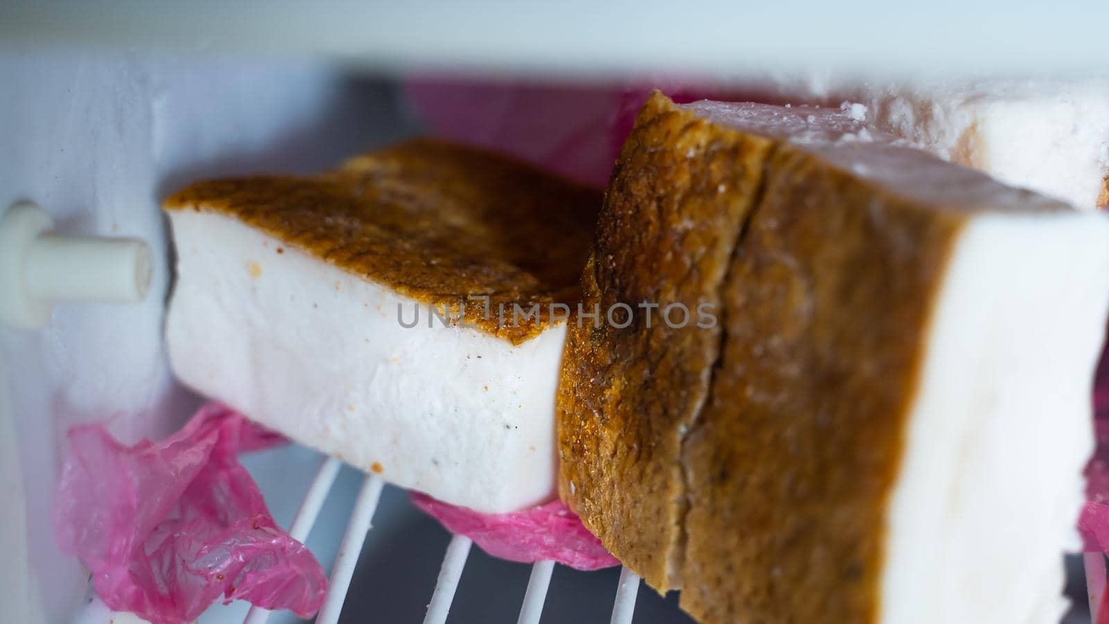 Ukrainian lard close-up in the freezer of the refrigerator. Fat layer under the skin of a pig close-up. salo without meat layer