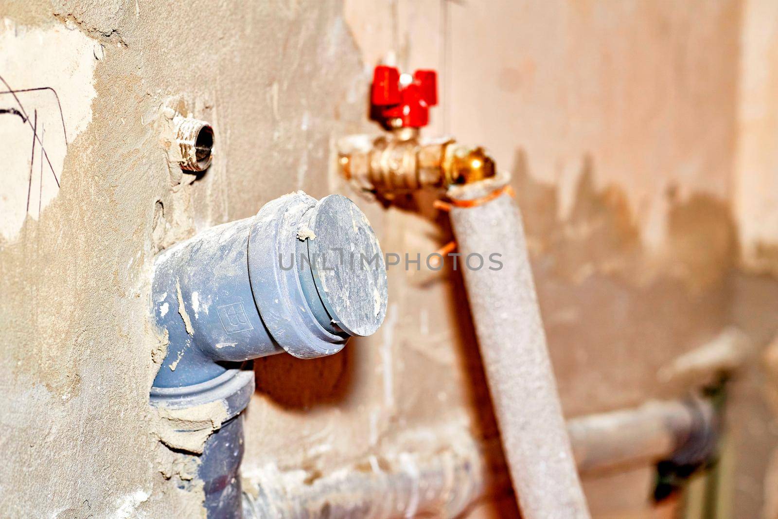 Hole with a pipe in the wall for connecting plumbing by jovani68