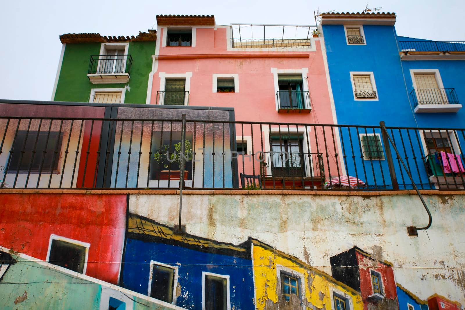 Villajoyosa, Alicante, Spain- April 22, 2022:Beautiful mural on the wall and Old colorful facades in Villajoyosa, Alicante, Spain