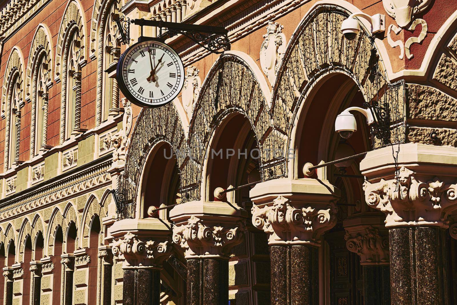 Street clock and old Gothic building in the afternoon by jovani68