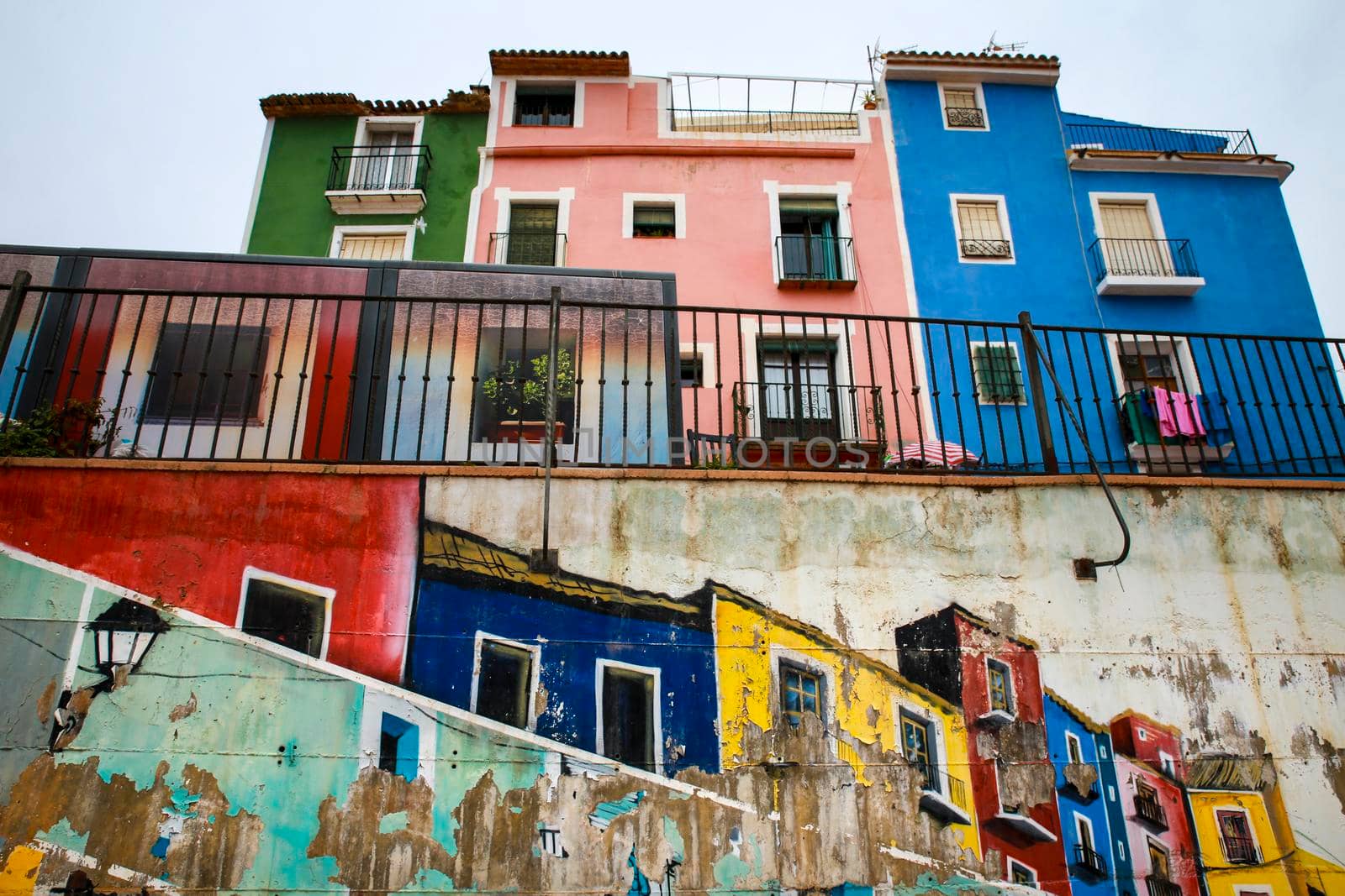 Villajoyosa, Alicante, Spain- April 22, 2022:Beautiful mural on the wall and Old colorful facades in Villajoyosa, Alicante, Spain