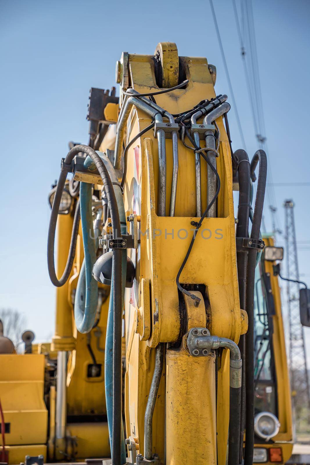 Part of modern yellow excavator machines. Vertical view