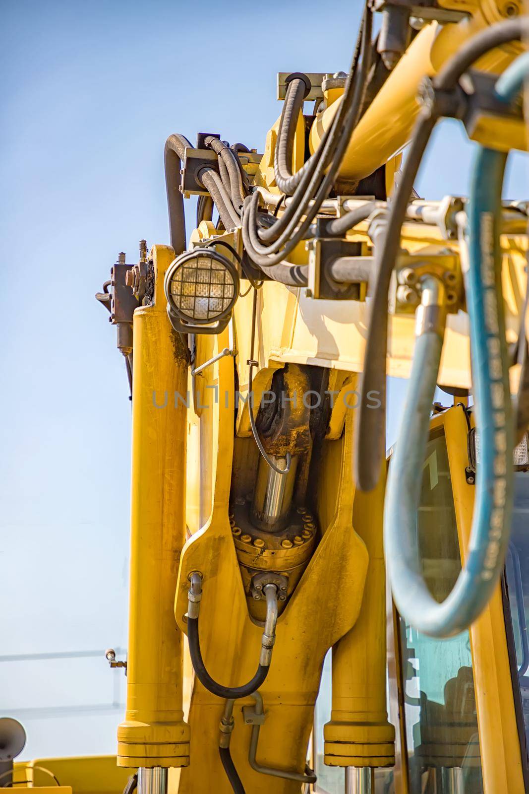 Part of modern yellow excavator machines. Vertical view