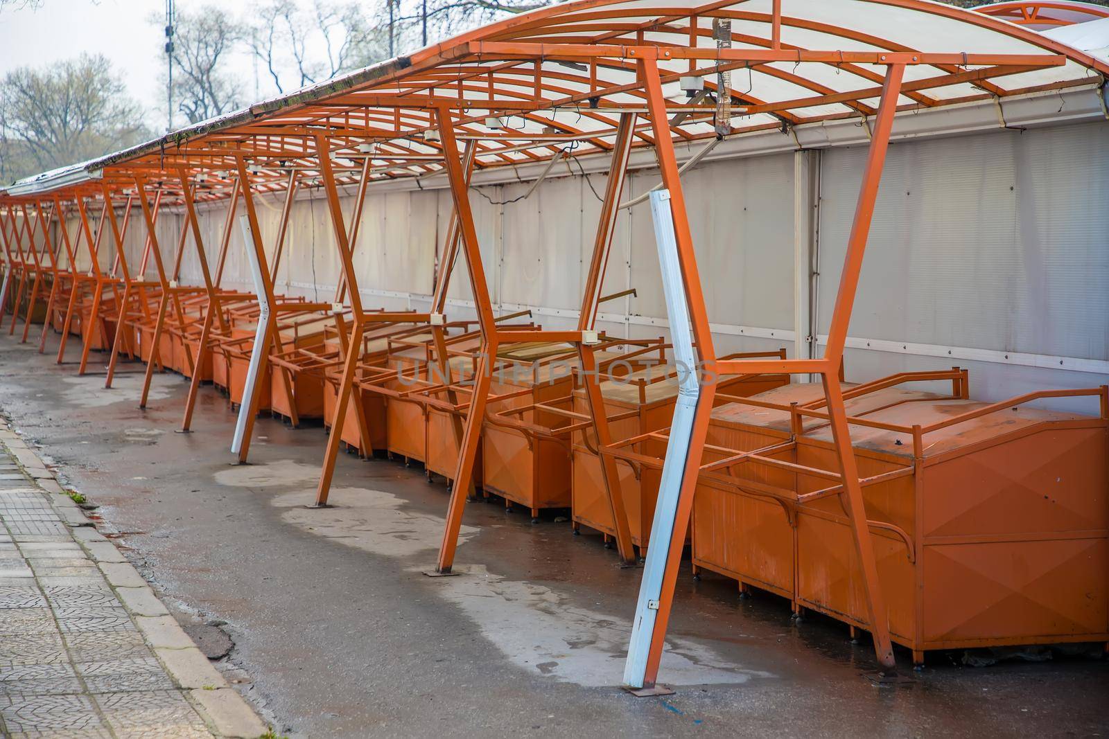 day view of many empty market stalls .
