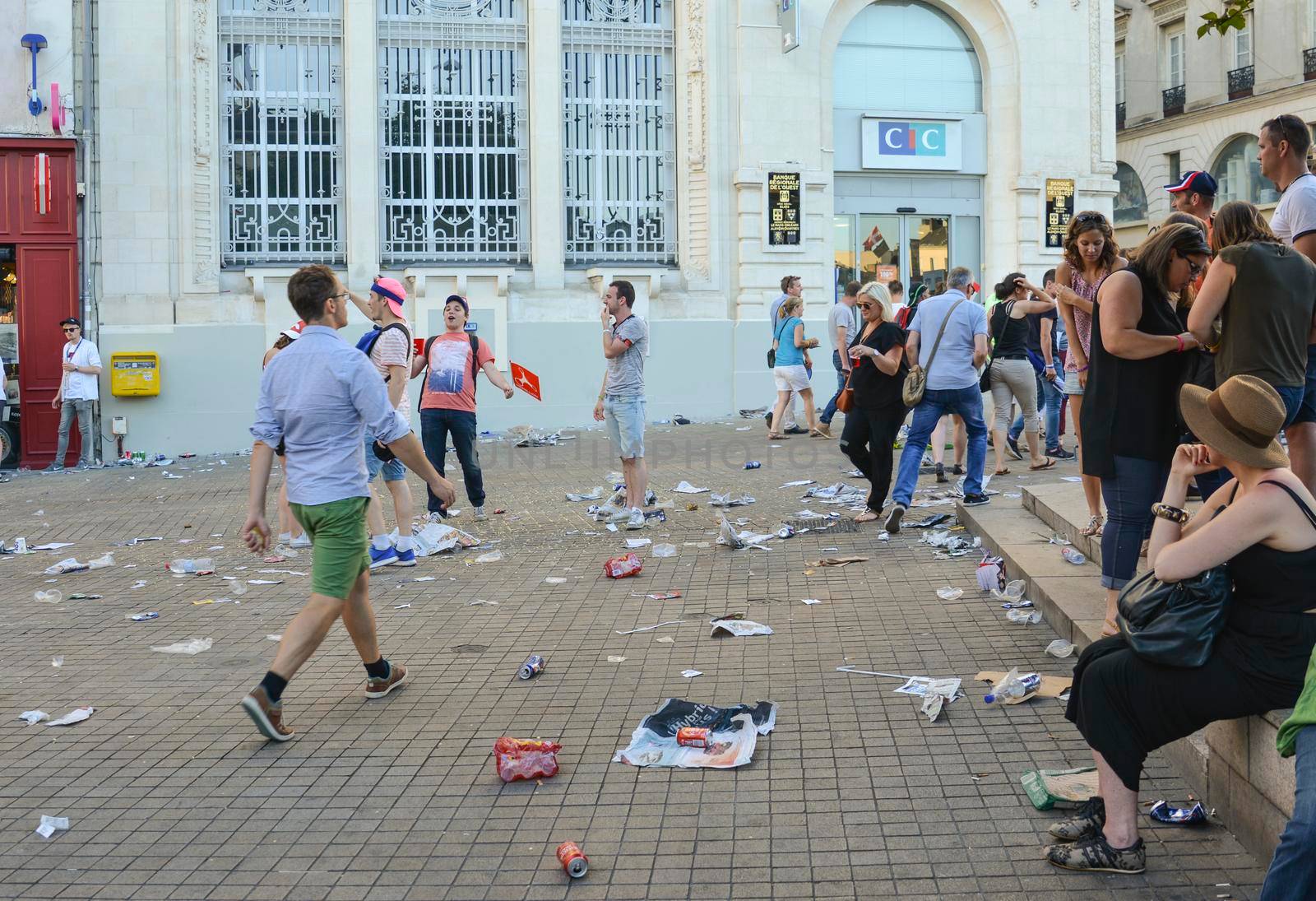 LE MANS, FRANCE - JUNE 16, 2017: Garbage from cans and plastic and paper on the street after the parade of pilots racing in Le mans, France