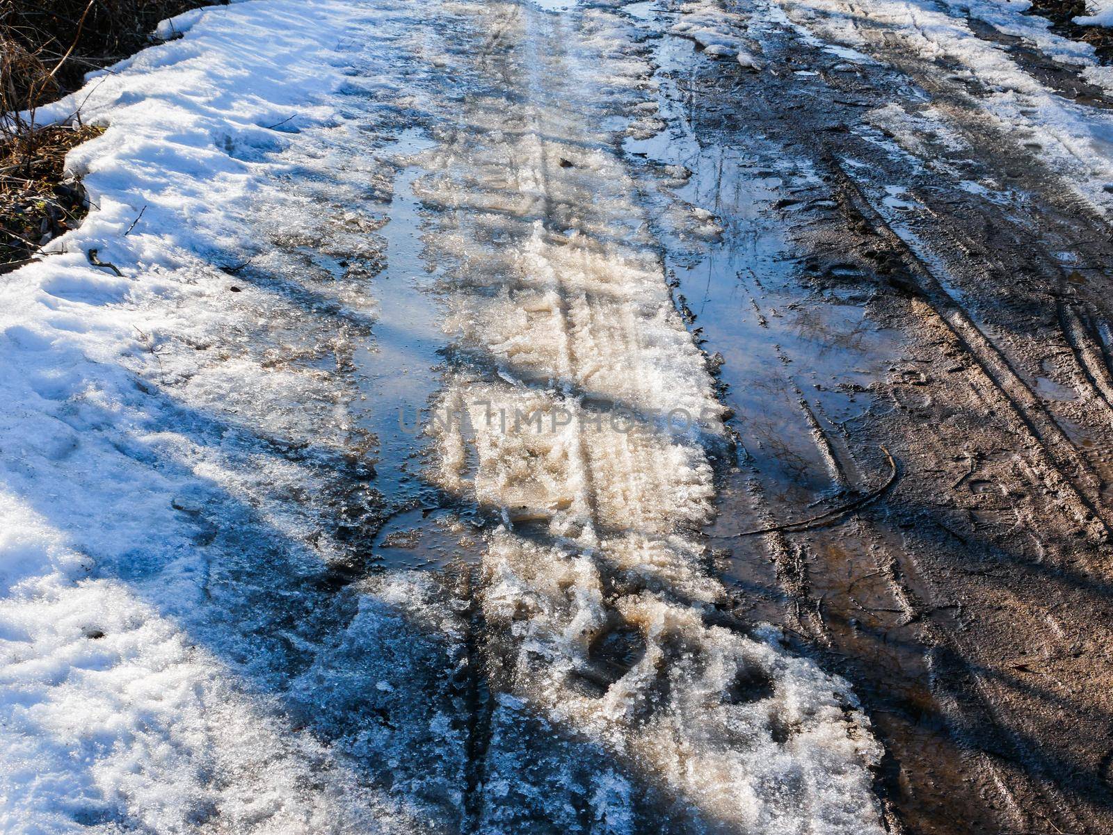 Country spring road with melted snow. by gelog67