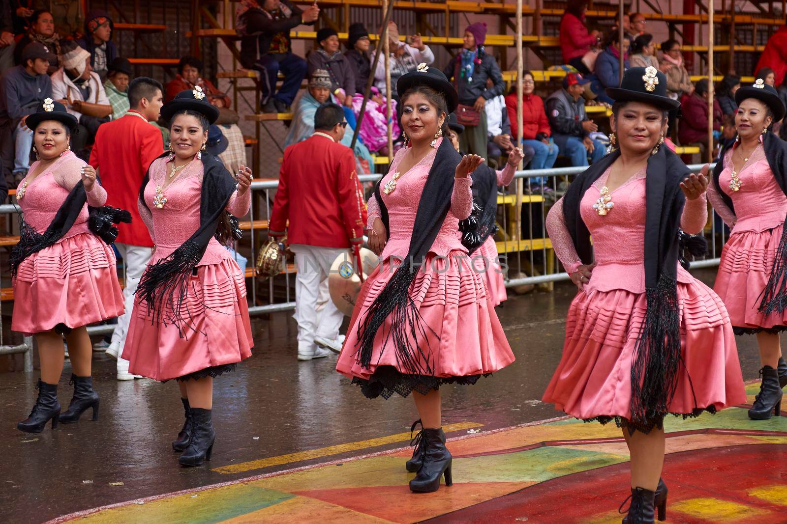 ORURO, BOLIVIA - FEBRUARY 25, 2017: Female Morenada dancers in colourful costumes parading through the mining city of Oruro on the Altiplano of Bolivia during the annual Oruro Carnival.