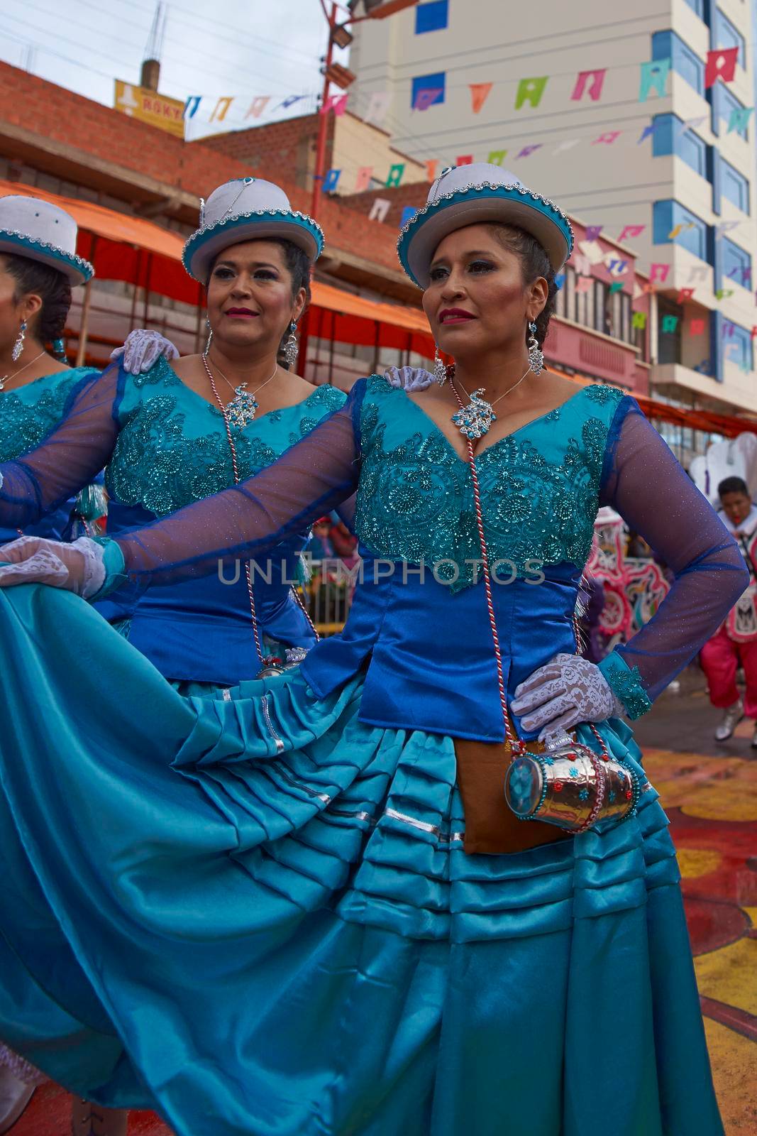 ORURO, BOLIVIA - FEBRUARY 25, 2017: Female Morenada dancers in colourful costumes parading through the mining city of Oruro on the Altiplano of Bolivia during the annual Oruro Carnival.