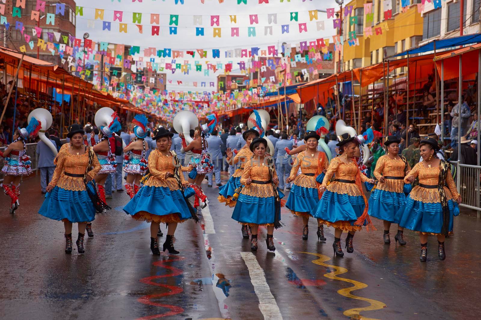 ORURO, BOLIVIA - FEBRUARY 25, 2017: Female Morenada dancers in colourful costumes parading through the mining city of Oruro on the Altiplano of Bolivia during the annual Oruro Carnival.