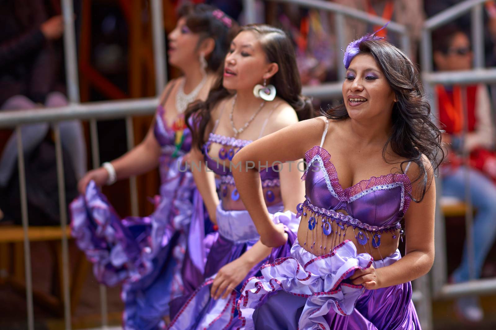 ORURO, BOLIVIA - FEBRUARY 25, 2017: Female dancers in colourful costumes parade through the mining city of Oruro on the Altiplano of Bolivia during the annual carnival.