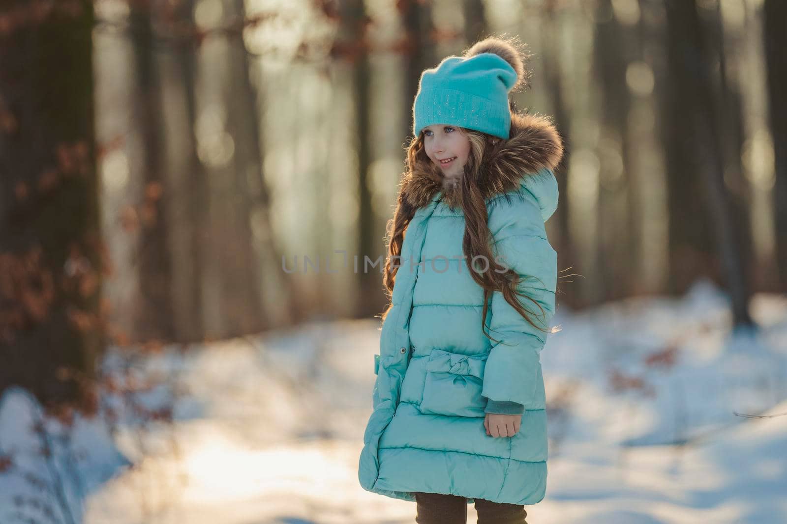 girl standing in a snowy forest