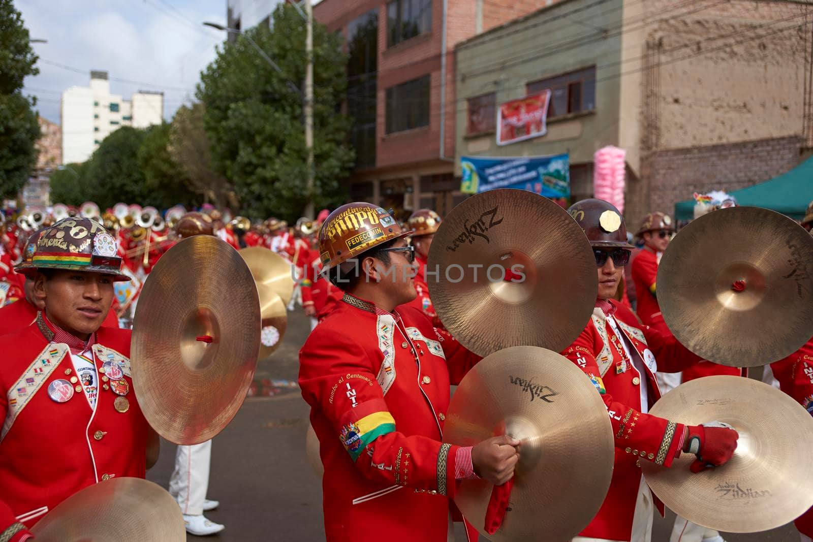 ORURO, BOLIVIA - FEBRUARY 25, 2017: Band of a Morenada dance group in colourful outfits parading through the mining city of Oruro on the Altiplano of Bolivia during the annual Oruro Carnival.