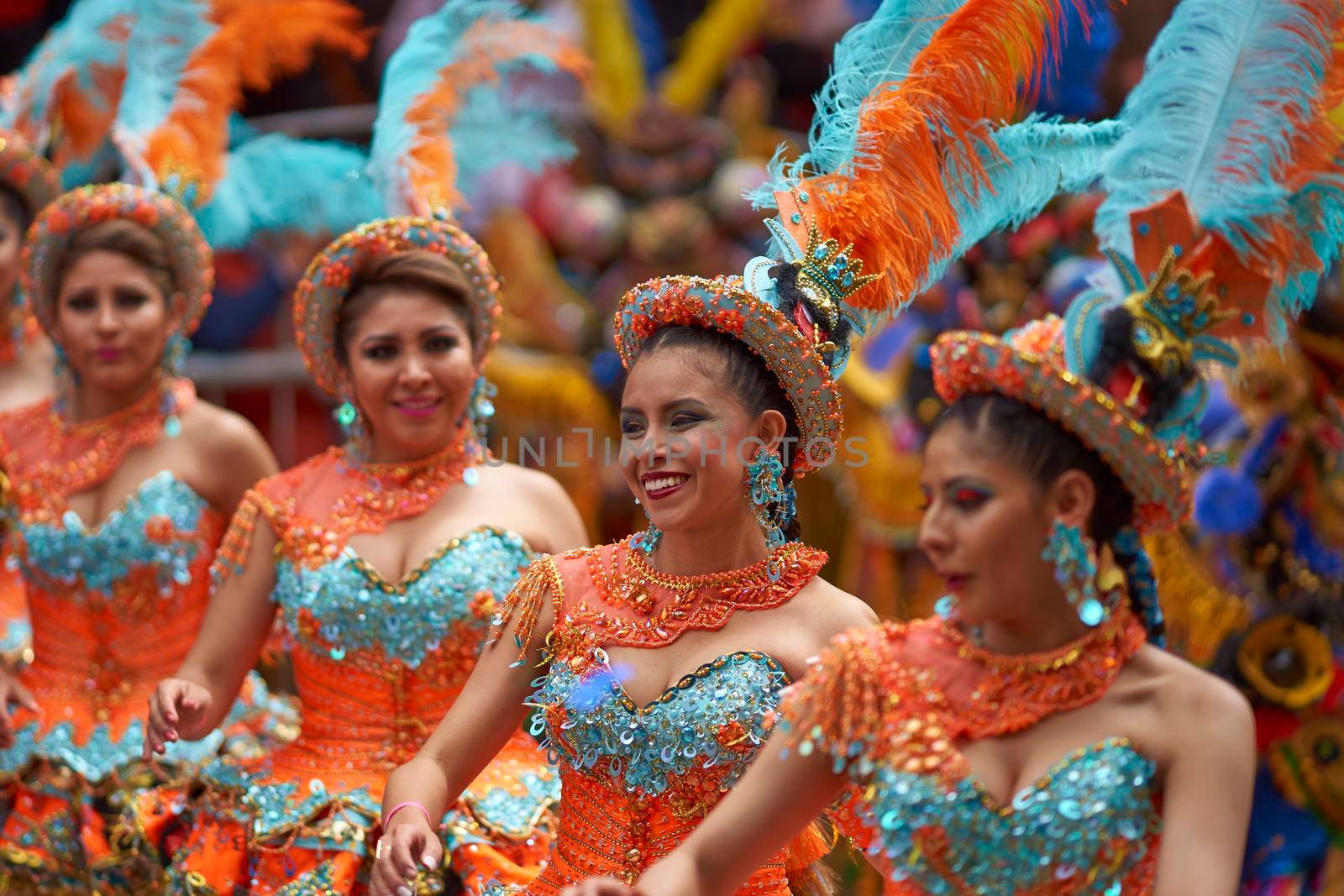 ORURO, BOLIVIA - FEBRUARY 25, 2017: Female Morenada dancers in colourful costumes parading through the mining city of Oruro on the Altiplano of Bolivia during the annual Oruro Carnival.