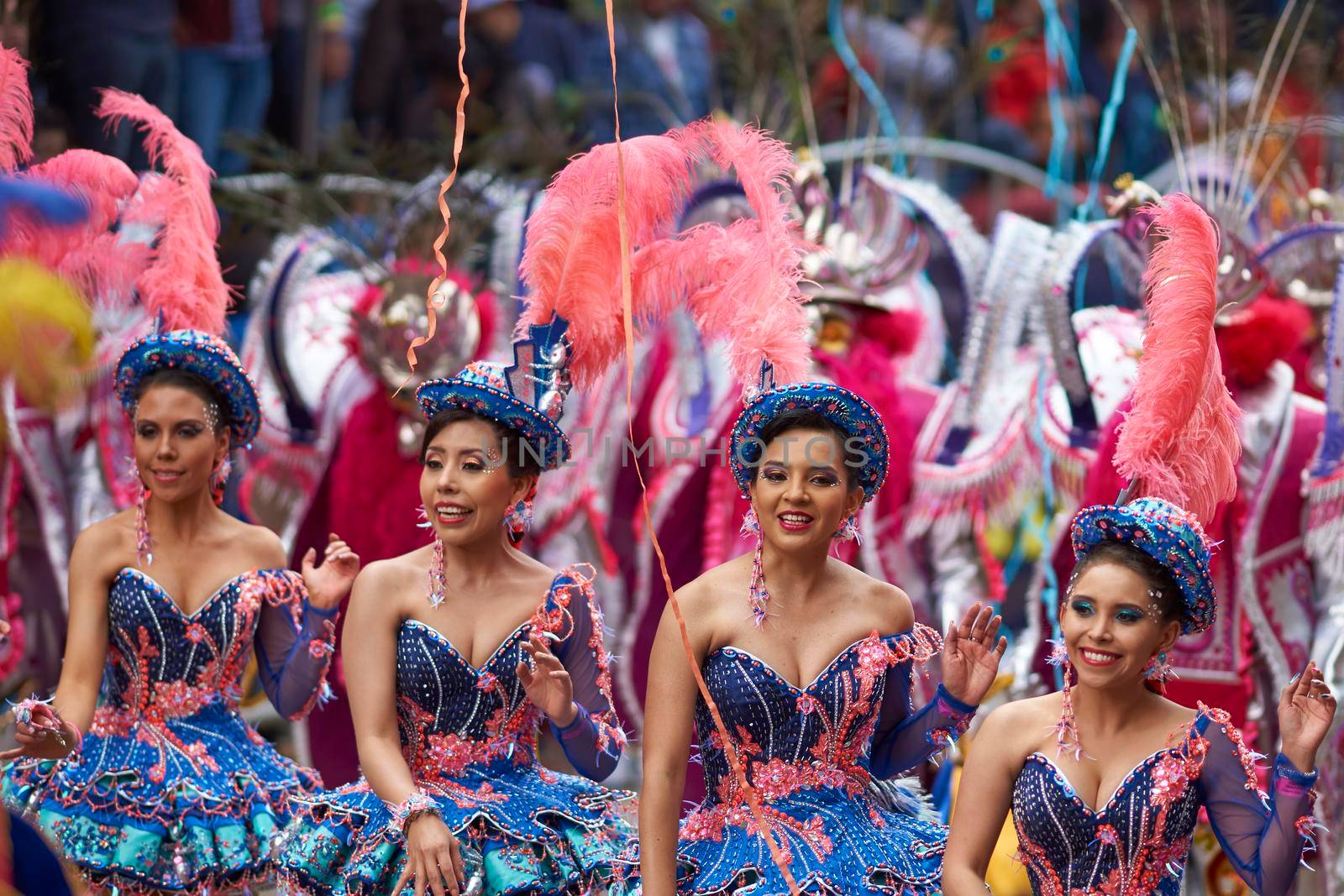 ORURO, BOLIVIA - FEBRUARY 25, 2017: Female Morenada dancers in colourful costumes parading through the mining city of Oruro on the Altiplano of Bolivia during the annual Oruro Carnival.