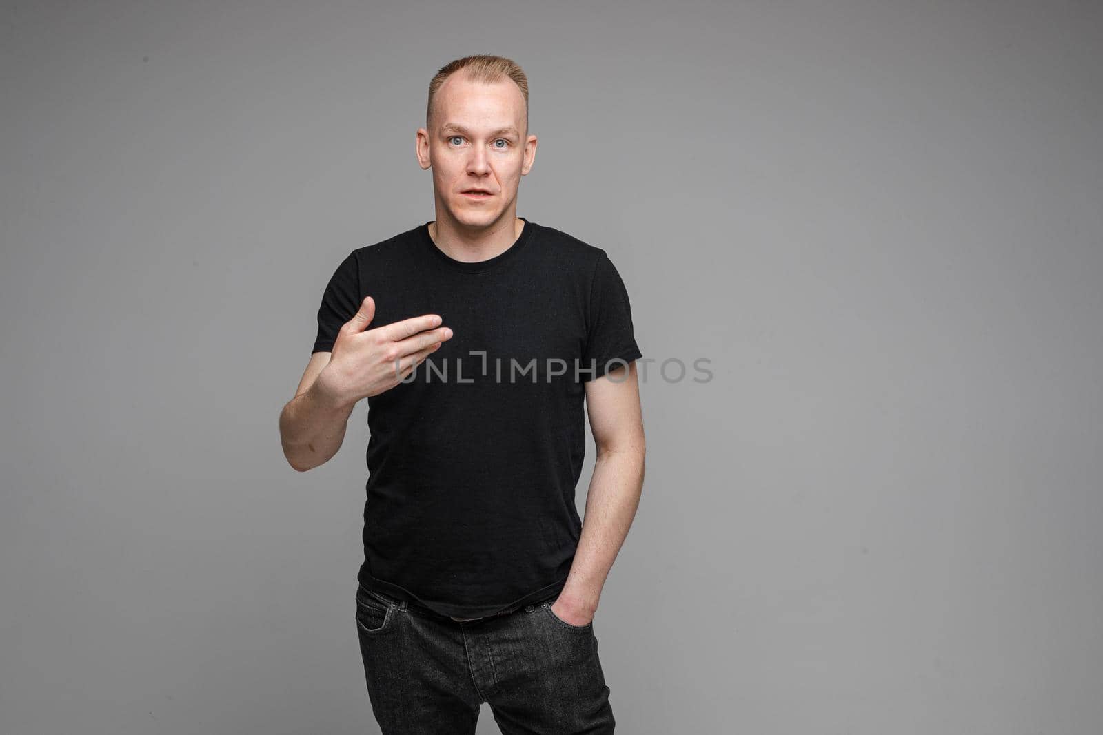 picture of handsome caucasian male isn't uderstand something isolated on grey background