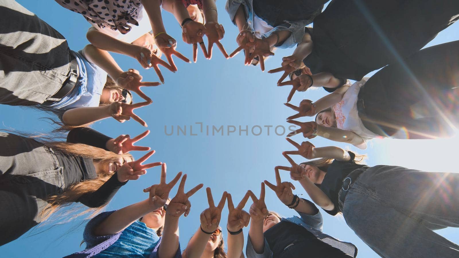 A group of girls makes a circle from their fingers