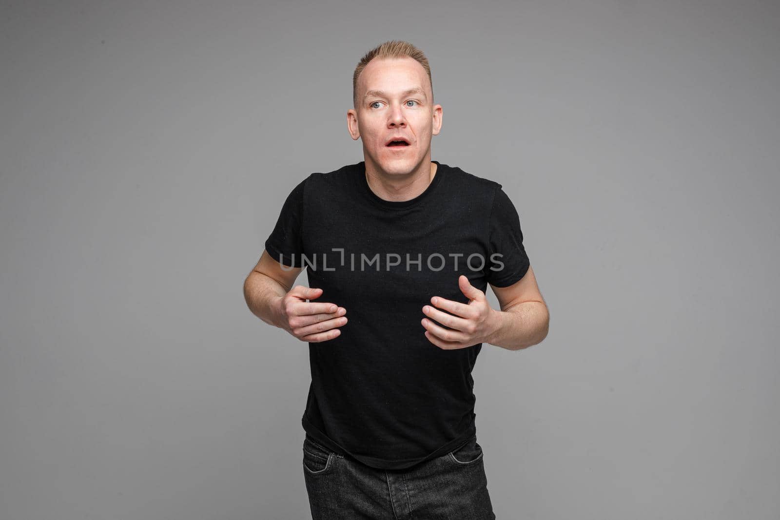picture of handsome caucasian male explain something isolated on grey background