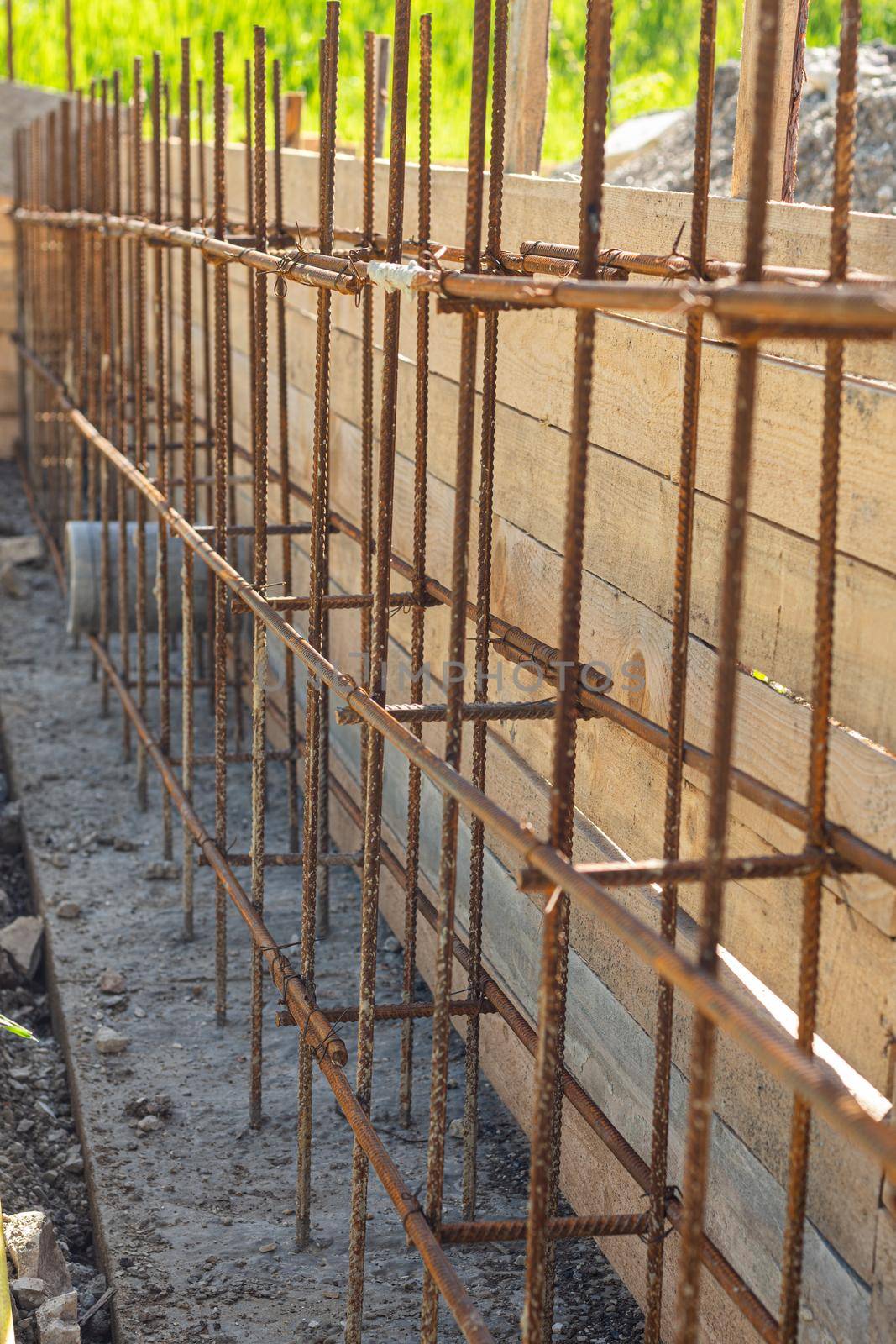 Construction of a strip foundation, reinforcement strapping, formwork in the background a