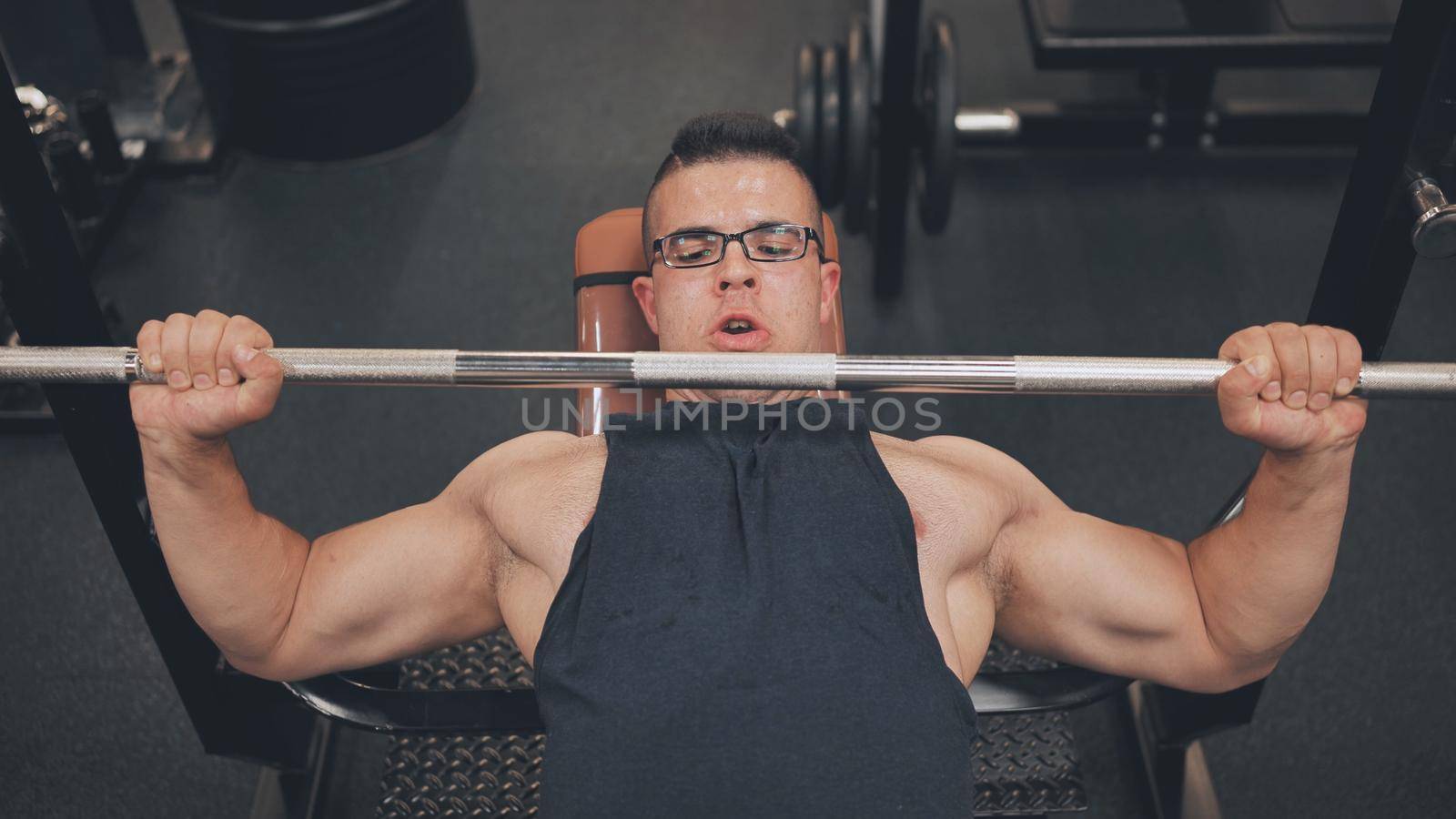 An Arab man pumps his chest in the gym. by DovidPro