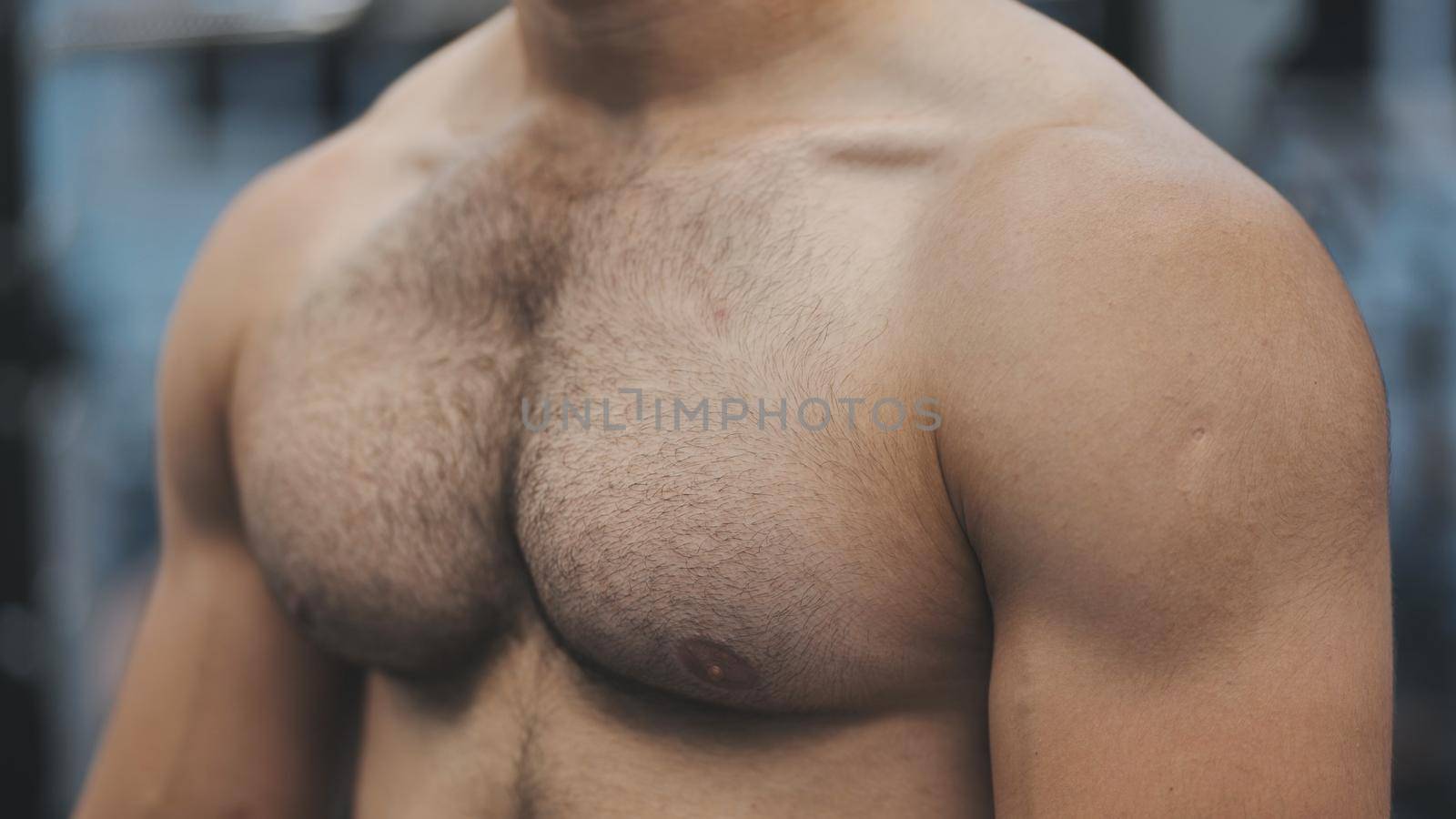 A man moves his strong and muscular chest.