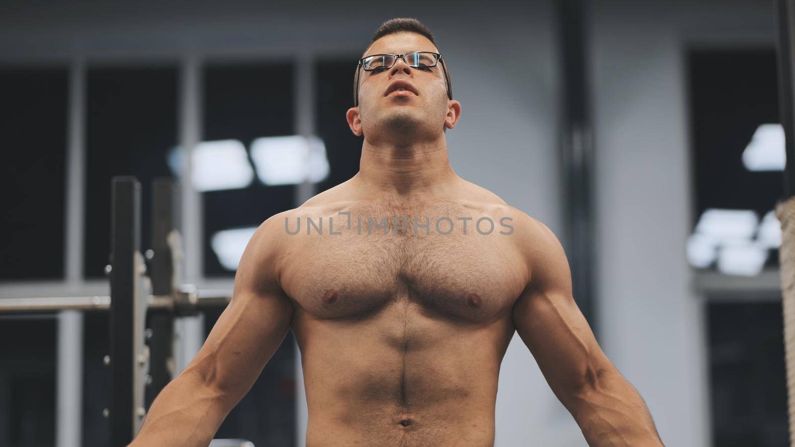 Muscular arab man posing in the gym. by DovidPro
