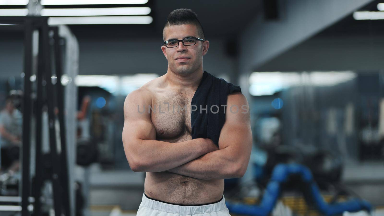 Muscular Arab in the gym after a workout. by DovidPro