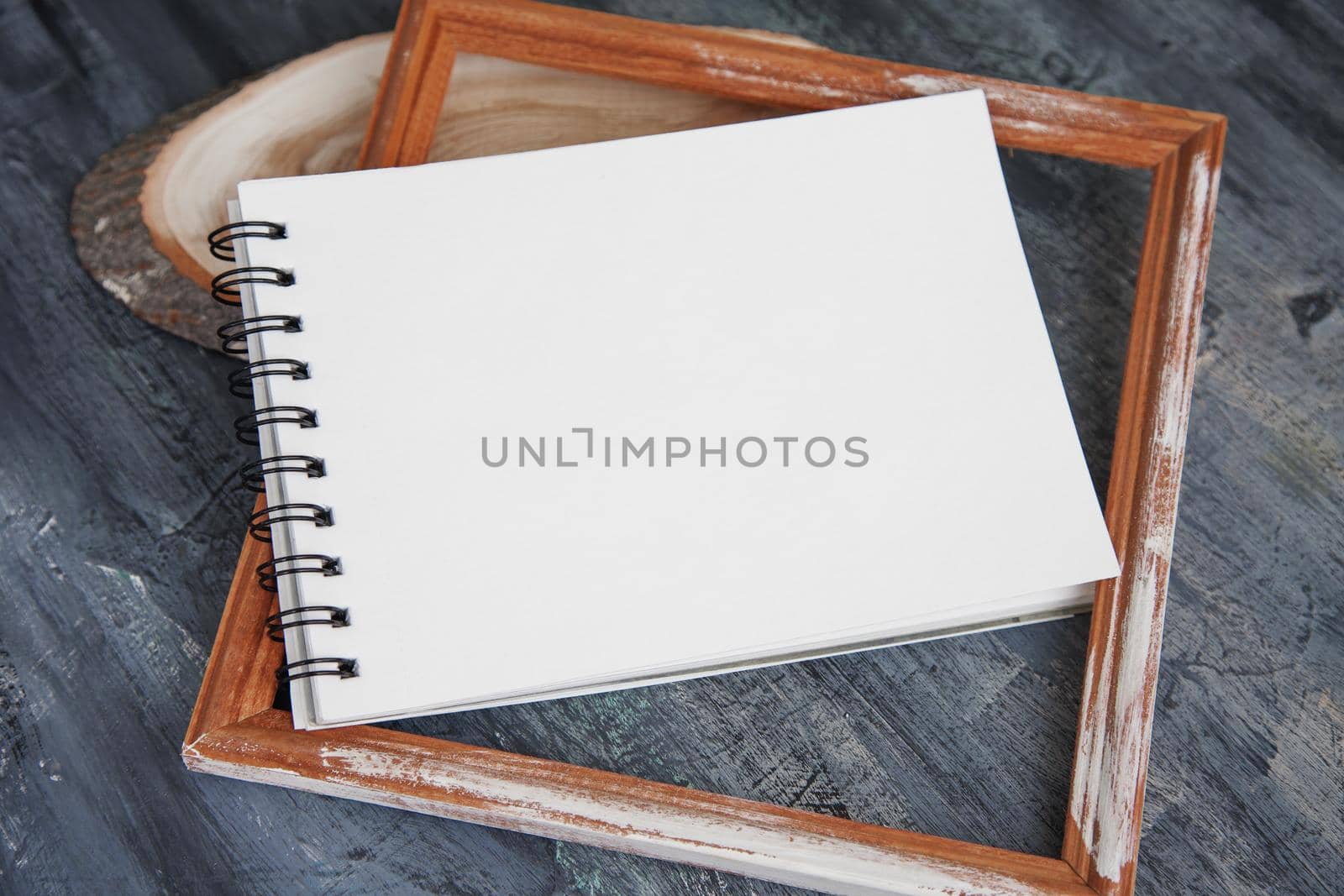 Artistic notepads with empty pages on black wood table background for portfolio design