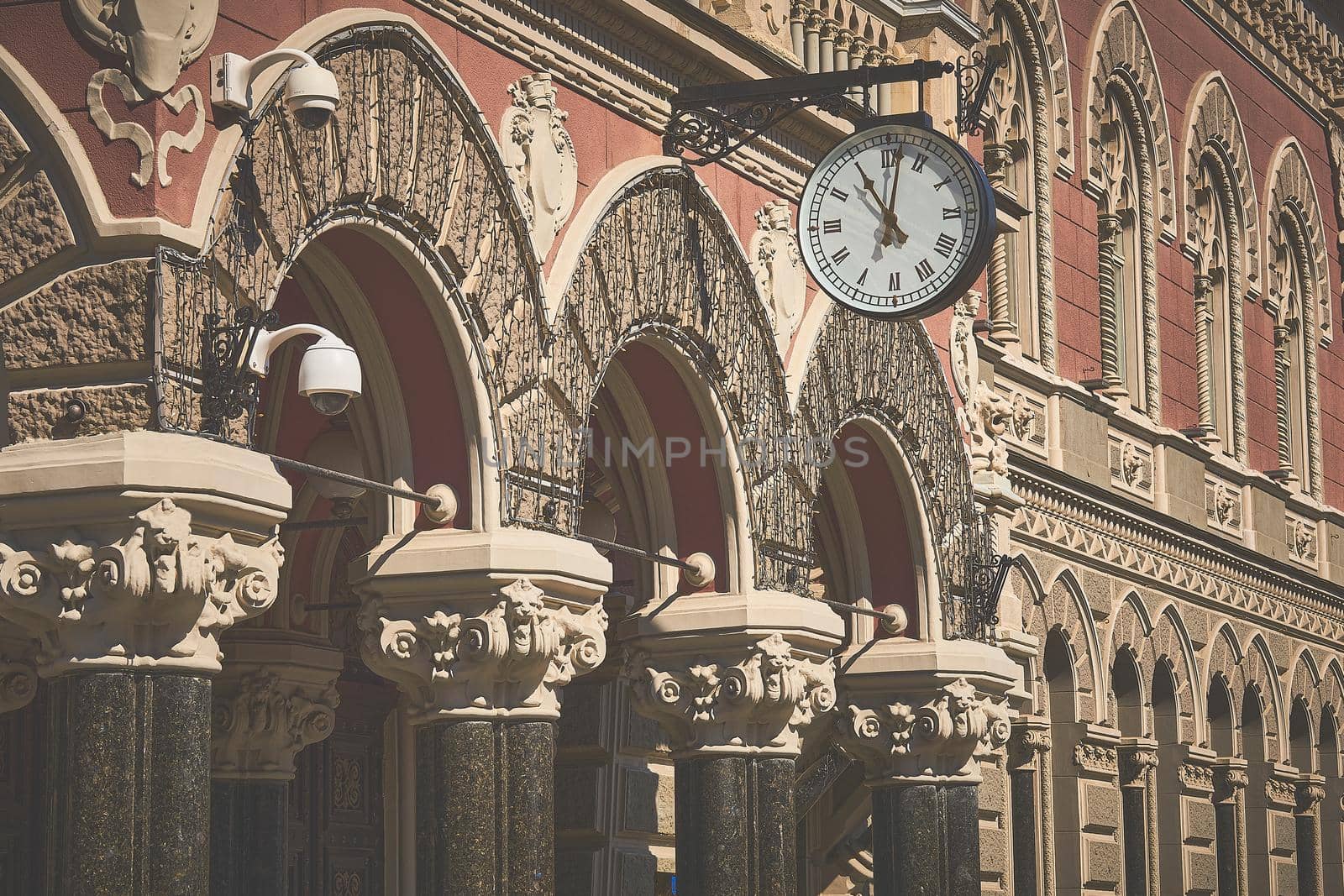Entrance with a clock in an ancient building with columns in Kiev Ukraine by jovani68
