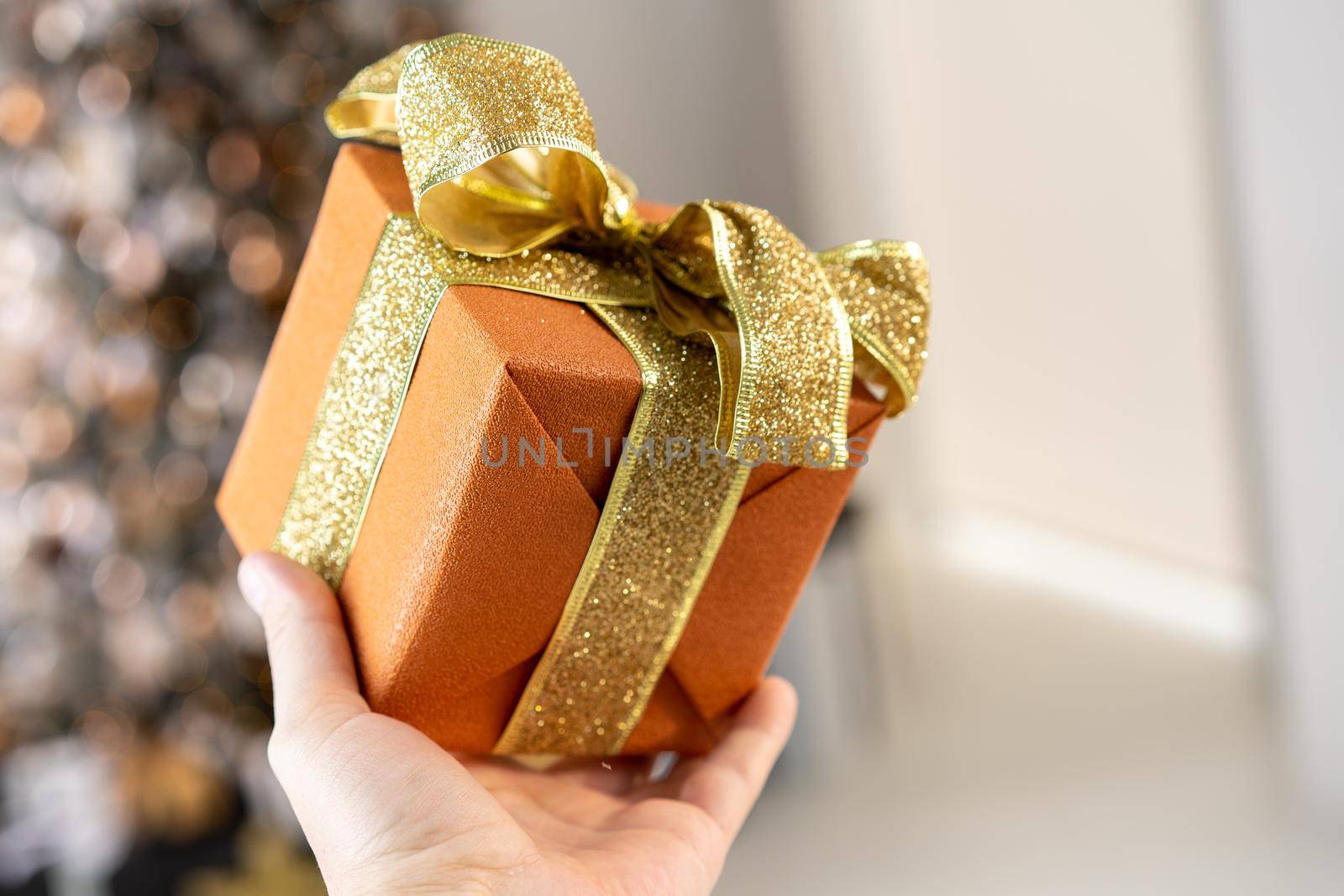 Christmas present gift box stacked close up. Holiday sale concept. Many gift box black, white, orange color with gold ribbon and light garland