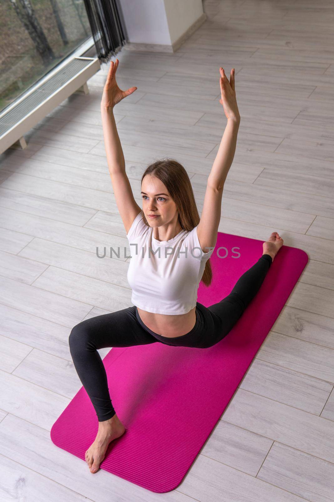 A exercises a a in fitness on shows girl mat club fitness window mfr, from home indoor for active and lifestyle body, pilates girl. Happy position copy, shape smiling practicing pose