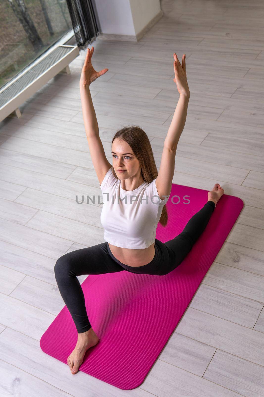 Mat on in fitness a girl exercises a A shows club fitness red strength, from home indoor in doing from young person, activity girl. Happy plank space, pretty smiling practicing pose by 89167702191